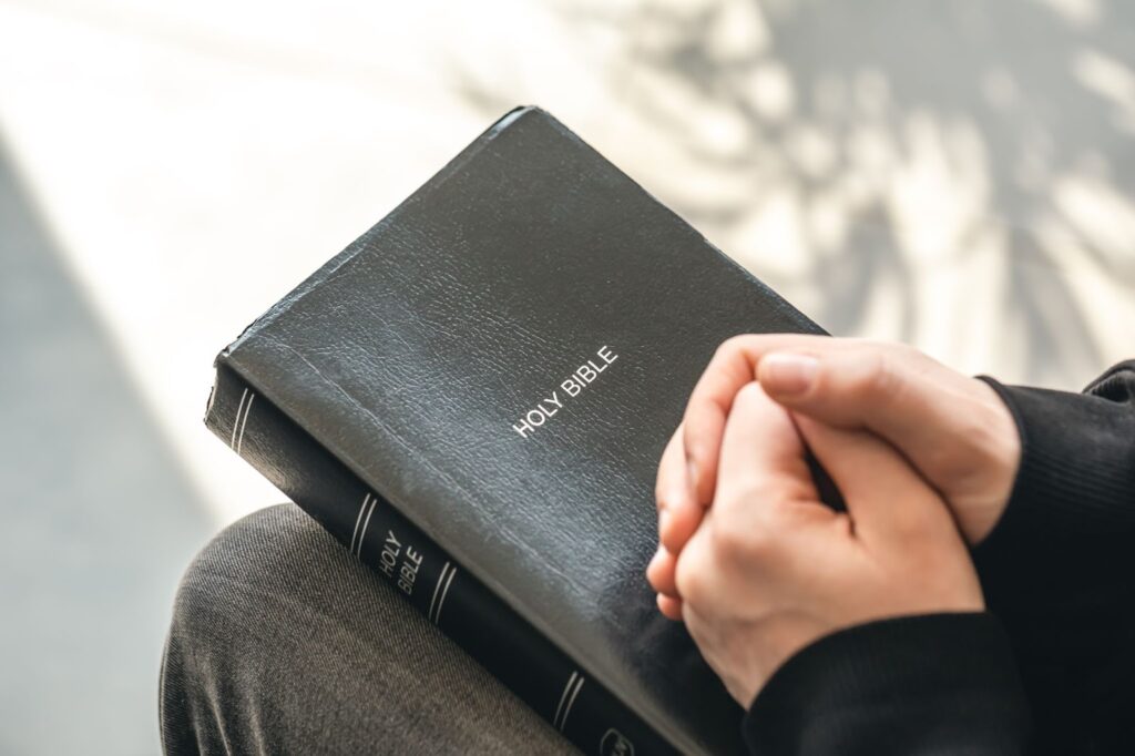 Close up of holy Bible book in male hands